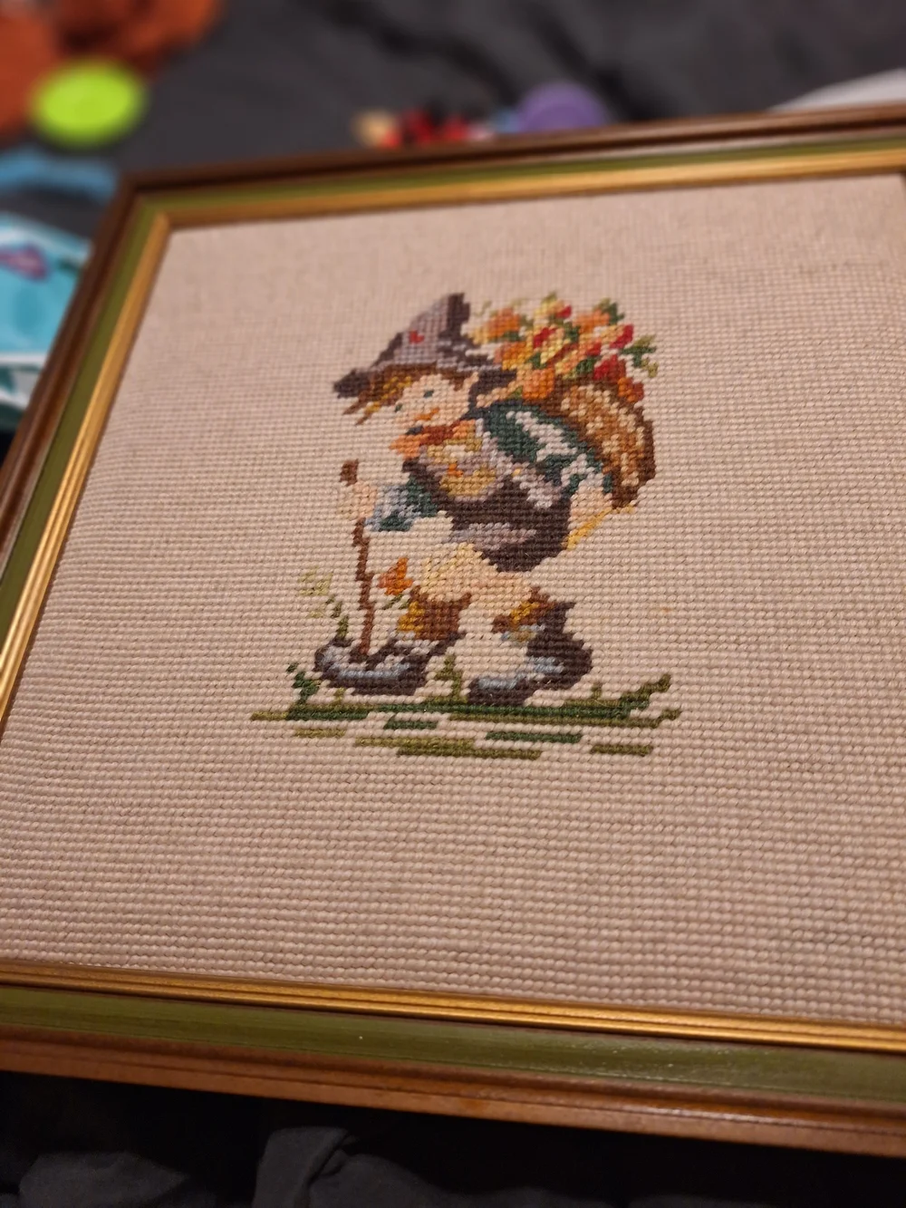 a pair of vintage Hummel framed needlepoint pictures featuring a boy a Girl